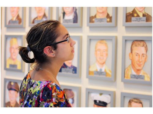 Woman looking at Wall of Heroes