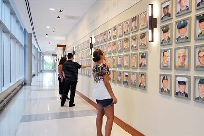 People Looking at Wall of Heroes